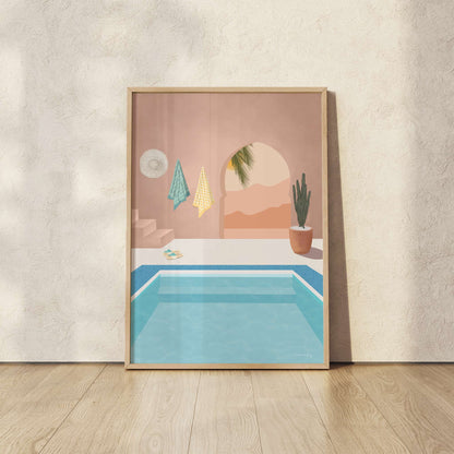 Framed artwork of a pool scene with a pink wall and palm tree, on a beige wall.