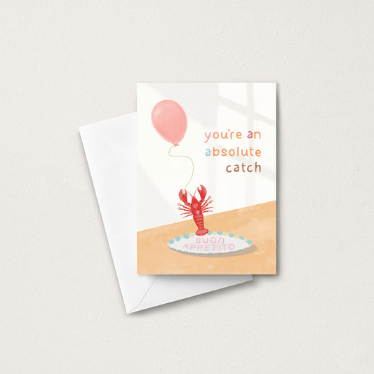Greeting card with a lobster and balloon illustration and text 'you're an absolute catch' on a white background.