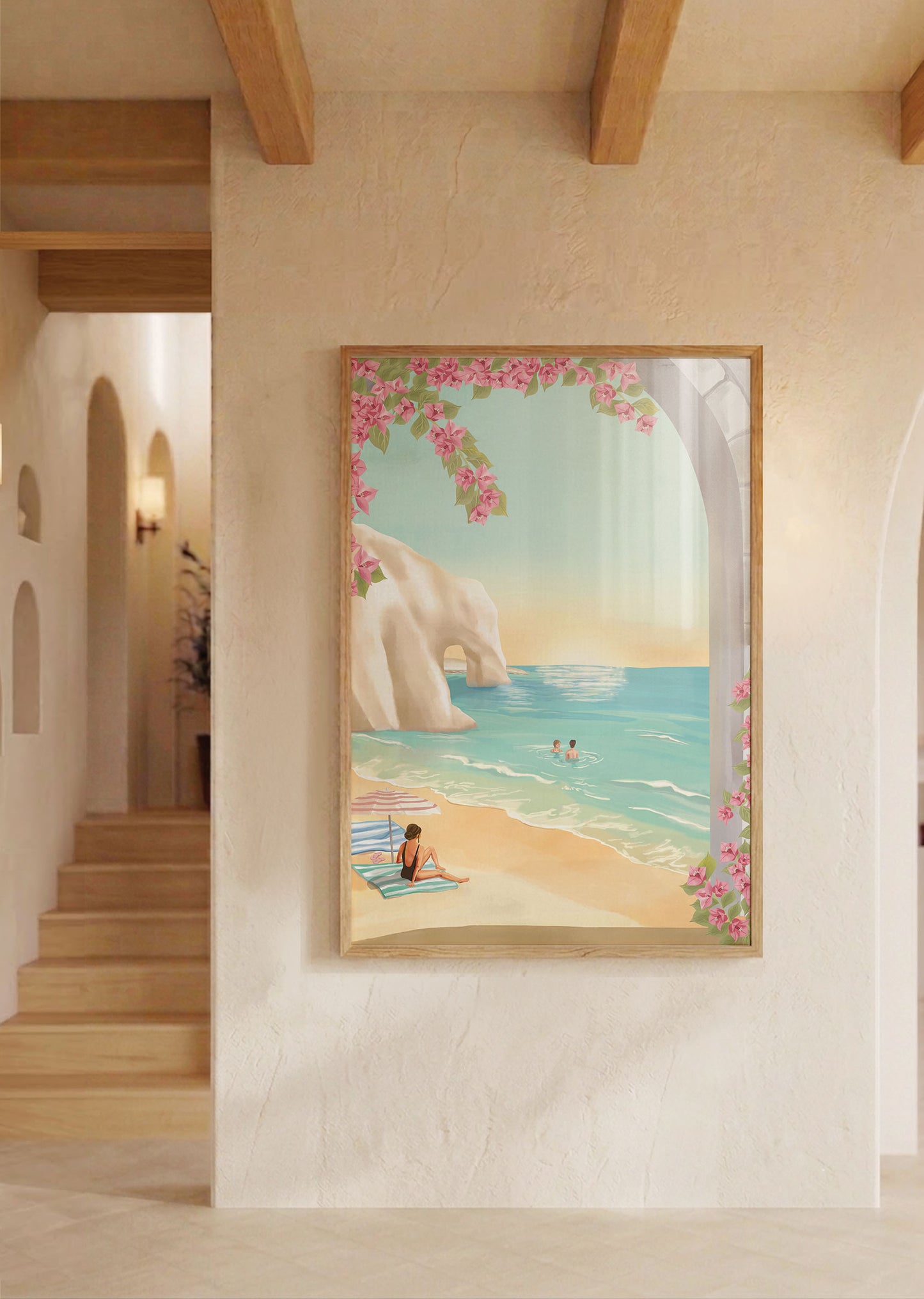 Framed artwork of a beach scene with a woman on a towel, hanging on a wall in a home.