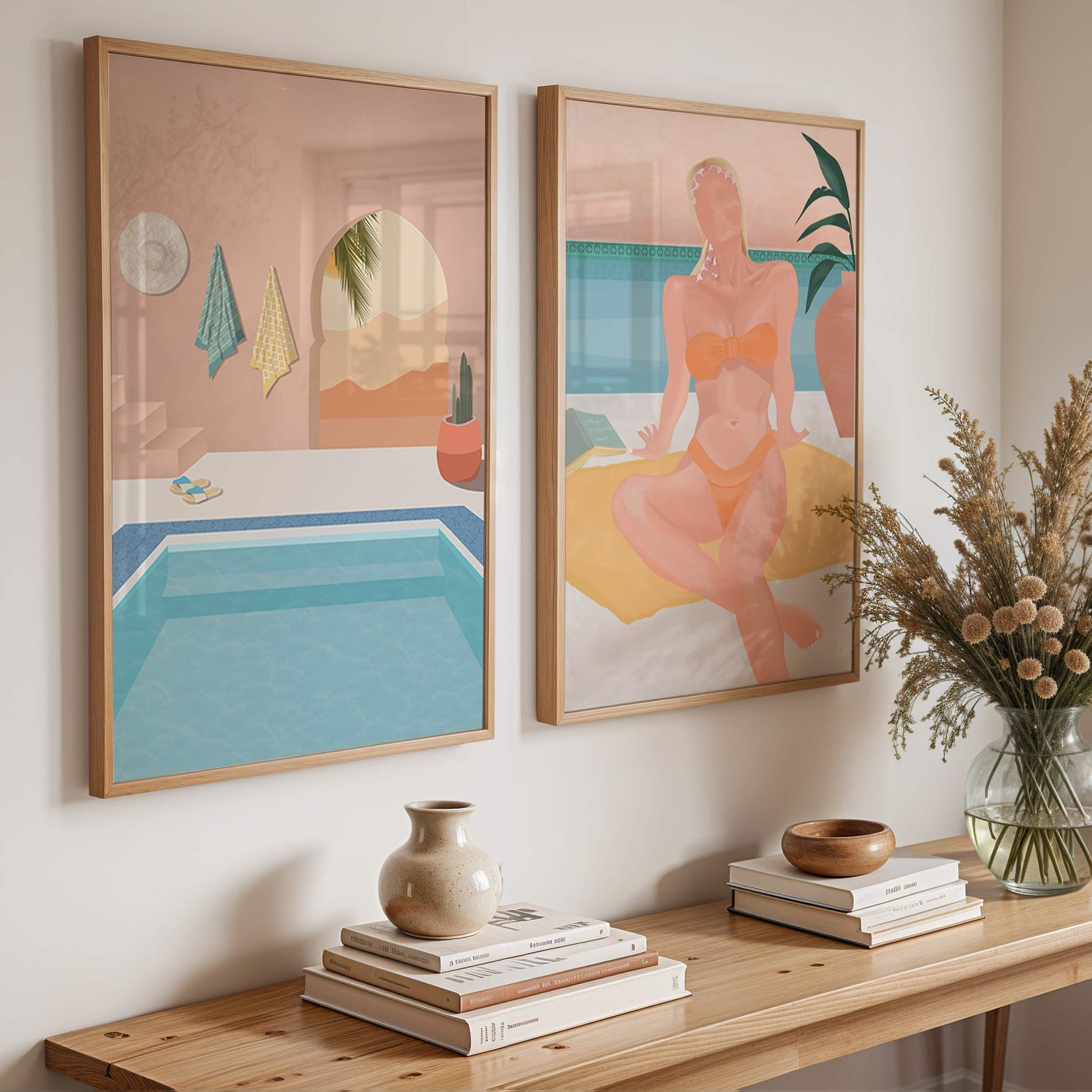 Two framed artworks on a wall above a wooden console table with decorative items.