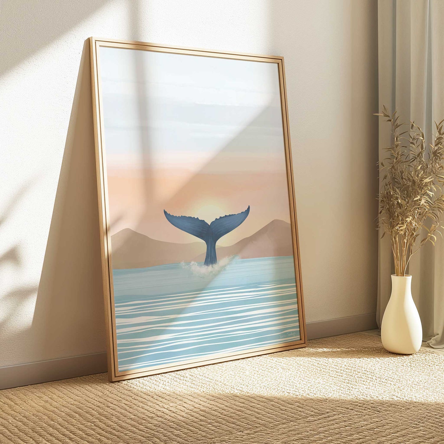 Framed artwork of a whale tail emerging from water on a wall in a room with a vase and plant.